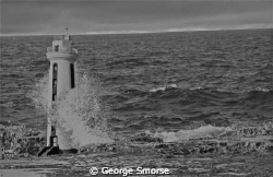 Bonaire's Lacre Punt Lighthouse at high tide - July 2010 by George Smorse 